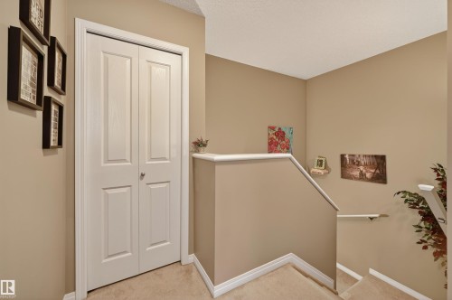 Staircase featuring carpet flooring and baseboards - 14 1140 Chappelle Boulevard, Edmonton, AB - Indoor Photo Showing Other Room