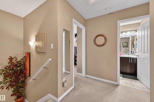 Corridor featuring an upstairs landing and light colored carpet - 14 1140 Chappelle Boulevard, Edmonton, AB - Indoor Photo Showing Other Room