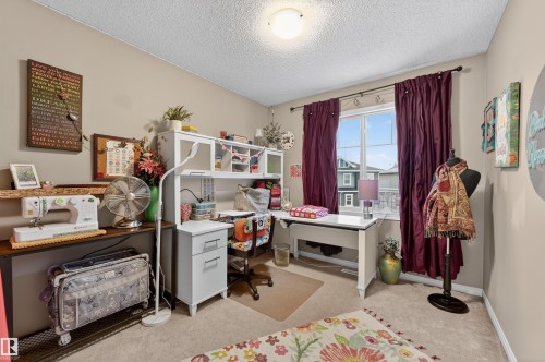Home office featuring light carpet and a textured ceiling - 14 1140 Chappelle Boulevard, Edmonton, AB - Indoor