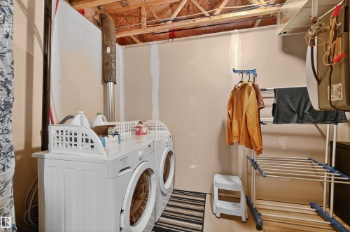 Laundry room with washing machine and dryer - 14 1140 Chappelle Boulevard, Edmonton, AB - Indoor Photo Showing Laundry Room