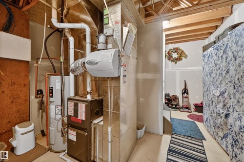 Utilities featuring heating unit and water heater - 14 1140 Chappelle Boulevard, Edmonton, AB - Indoor Photo Showing Basement