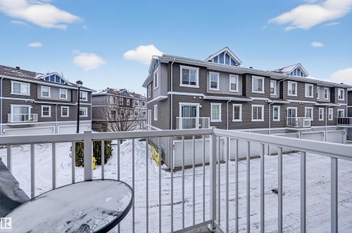 Snow covered back of property with a residential view - 14 1140 Chappelle Boulevard, Edmonton, AB - Outdoor With Balcony