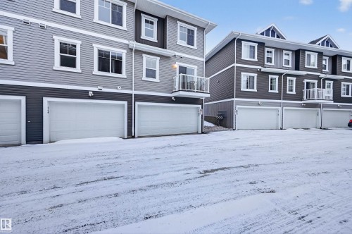 View of front of property featuring a balcony, a garage, and a residential view - 14 1140 Chappelle Boulevard, Edmonton, AB - Outdoor