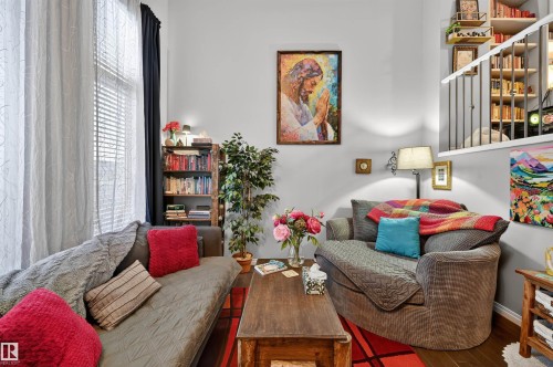 Living area featuring wood finished floors and baseboards - 14 1140 Chappelle Boulevard, Edmonton, AB - Indoor Photo Showing Living Room