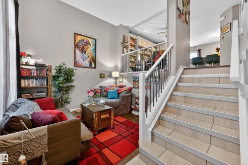 Stairway with baseboards and wood finished floors - 14 1140 Chappelle Boulevard, Edmonton, AB - Indoor Photo Showing Other Room