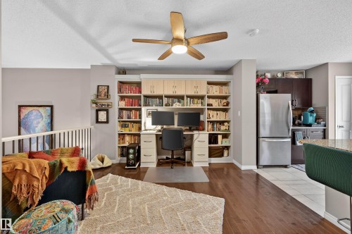 Office area with a ceiling fan, dark wood finished floors, and a textured ceiling - 14 1140 Chappelle Boulevard, Edmonton, AB - Indoor