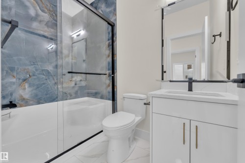 Bathroom featuring vanity and a marble finish shower - 231 Crystal Creek Drive, Leduc, AB - Indoor Photo Showing Bathroom