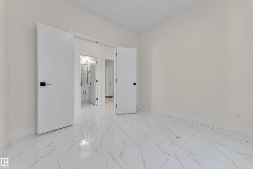 Unfurnished bedroom featuring baseboards and ensuite bath - 231 Crystal Creek Drive, Leduc, AB - Indoor Photo Showing Other Room