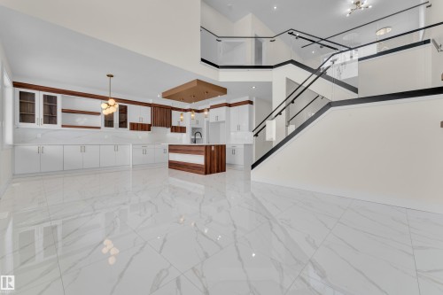 Unfurnished living room with light marble finish flooring, recessed lighting, and a high ceiling - 231 Crystal Creek Drive, Leduc, AB - Indoor Photo Showing Other Room
