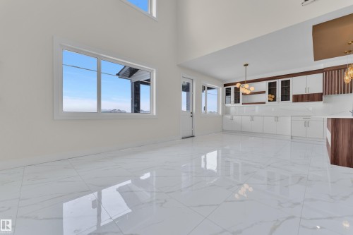 Unfurnished living room with light marble finish floors and a high ceiling - 231 Crystal Creek Drive, Leduc, AB - Indoor