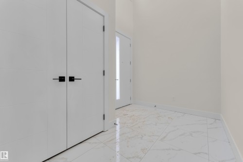 Entrance foyer with light marble finish flooring and baseboards - 231 Crystal Creek Drive, Leduc, AB - Indoor Photo Showing Other Room