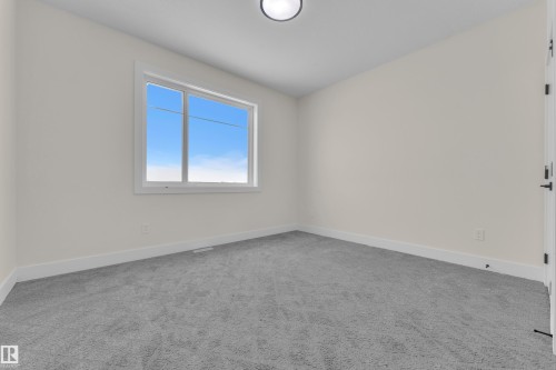 Spare room with light colored carpet and baseboards - 231 Crystal Creek Drive, Leduc, AB - Indoor Photo Showing Other Room