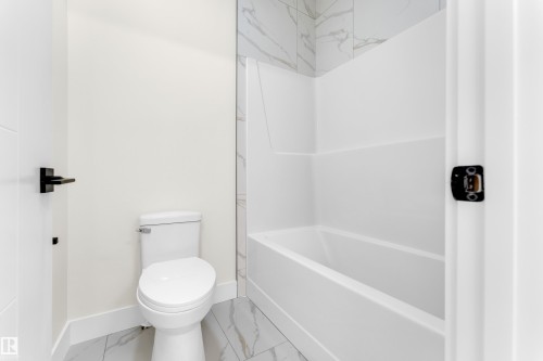 Full bath featuring light marble finish floors - 231 Crystal Creek Drive, Leduc, AB - Indoor Photo Showing Bathroom