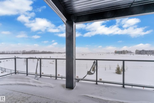 Snow covered patio featuring a balcony - 231 Crystal Creek Drive, Leduc, AB - Outdoor With View