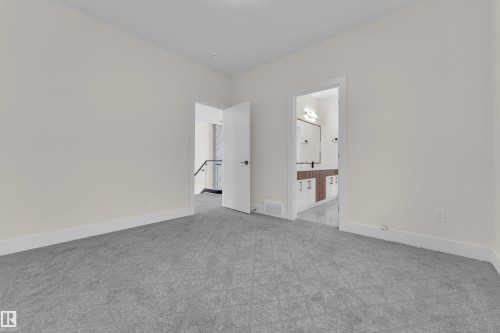 Unfurnished bedroom with light carpet and ensuite bath - 231 Crystal Creek Drive, Leduc, AB - Indoor Photo Showing Other Room