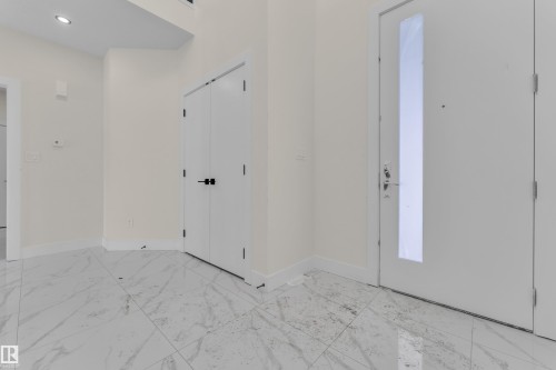 Foyer entrance with light marble finish floors and recessed lighting - 231 Crystal Creek Drive, Leduc, AB - Indoor Photo Showing Other Room