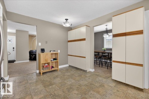 Empty room featuring a textured ceiling and stone finish floors - 8804 38 Avenue, Edmonton, AB - Indoor