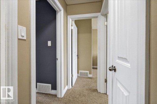 Corridor featuring light carpet and baseboards - 8804 38 Avenue, Edmonton, AB - Indoor Photo Showing Other Room
