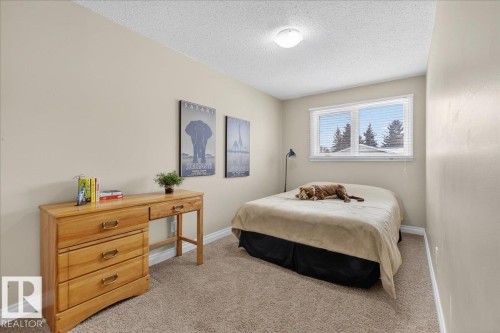 Bedroom with light colored carpet and a textured ceiling - 8804 38 Avenue, Edmonton, AB - Indoor Photo Showing Bedroom
