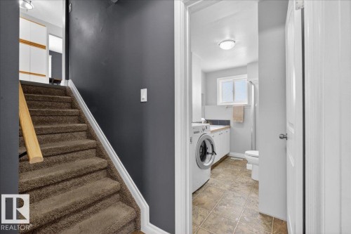 Laundry area with baseboards and washer / clothes dryer - 8804 38 Avenue, Edmonton, AB - Indoor Photo Showing Laundry Room