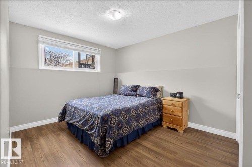 Bedroom featuring wood finished floors and a textured ceiling - 8804 38 Avenue, Edmonton, AB - Indoor Photo Showing Bedroom