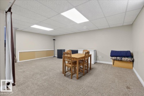 Dining room featuring a paneled ceiling and light colored carpet - 8804 38 Avenue, Edmonton, AB - Indoor Photo Showing Basement