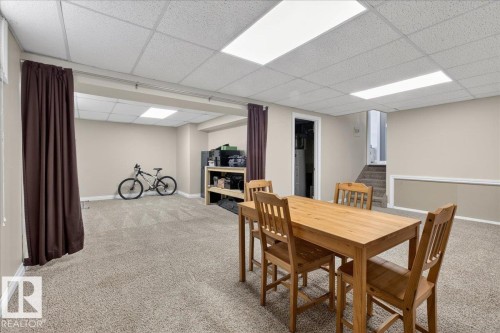 Dining room featuring light colored carpet and a paneled ceiling - 8804 38 Avenue, Edmonton, AB - Indoor Photo Showing Basement