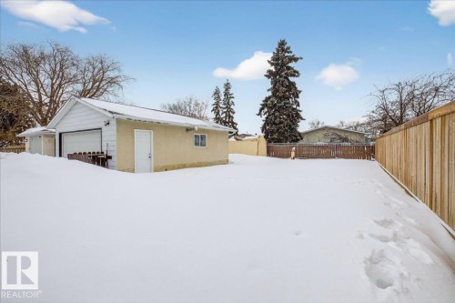 Snowy yard featuring an outdoor structure and a fenced backyard - 8804 38 Avenue, Edmonton, AB - Outdoor