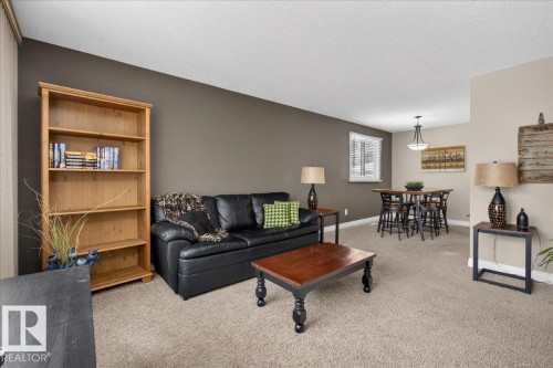 Living area featuring light colored carpet and a textured ceiling - 8804 38 Avenue, Edmonton, AB - Indoor Photo Showing Living Room