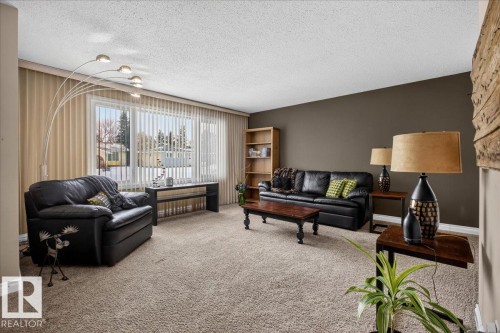 Living room with carpet floors and a textured ceiling - 8804 38 Avenue, Edmonton, AB - Indoor Photo Showing Living Room