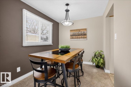 Dining space with light colored carpet and a textured ceiling - 8804 38 Avenue, Edmonton, AB - Indoor Photo Showing Dining Room