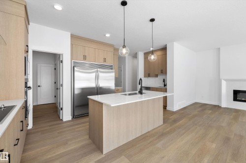1077 Cristall Crescent, Edmonton, AB - Indoor Photo Showing Kitchen With Fireplace With Double Sink With Upgraded Kitchen