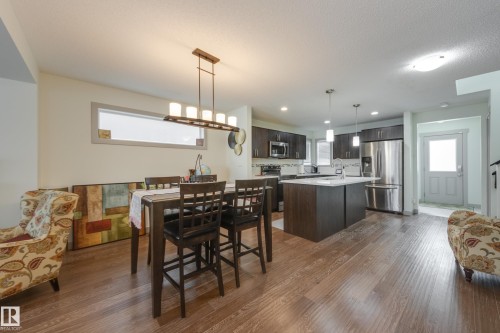 Dining room featuring dark wood finished floors and recessed lighting - 17528 58 Street, Edmonton, AB - Indoor