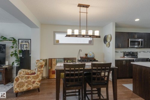 Dining space featuring dark wood finished floors and recessed lighting - 17528 58 Street, Edmonton, AB - Indoor Photo Showing Other Room