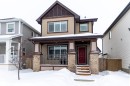 View of front facade featuring a porch, brick siding, and board and batten siding - 17528 58 Street, Edmonton, AB  - Outdoor With Facade 