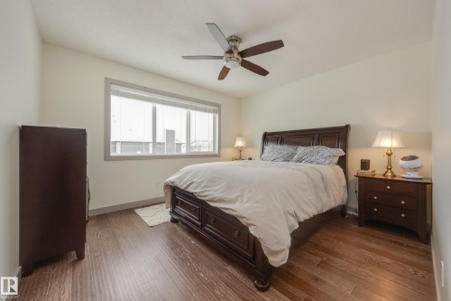 Bedroom featuring dark wood-type flooring and ceiling fan - 17528 58 Street, Edmonton, AB - Indoor Photo Showing Bedroom