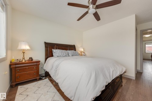Bedroom featuring dark wood-style floors and a ceiling fan - 17528 58 Street, Edmonton, AB - Indoor Photo Showing Bedroom