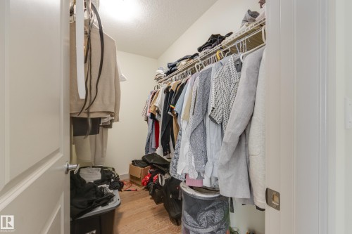 Walk in closet featuring light wood-style flooring - 17528 58 Street, Edmonton, AB - Indoor With Storage
