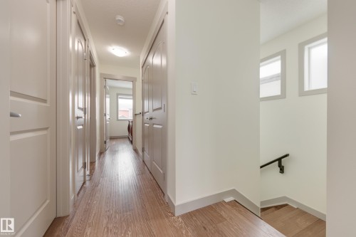 Hall with an upstairs landing and light wood-type flooring - 17528 58 Street, Edmonton, AB - Indoor Photo Showing Other Room