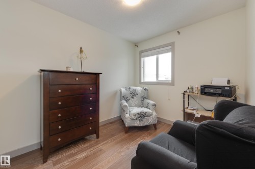 Sitting room featuring light wood-style floors and baseboards - 17528 58 Street, Edmonton, AB - Indoor