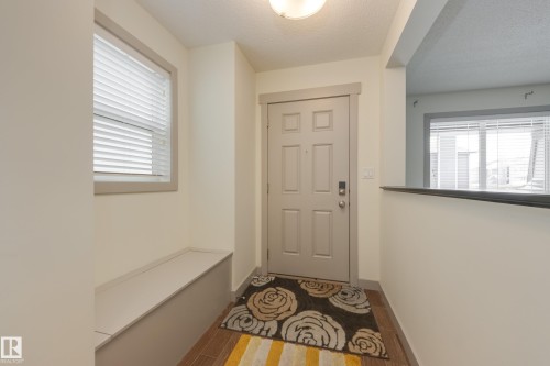 Doorway with wood finished floors and a textured ceiling - 17528 58 Street, Edmonton, AB - Indoor Photo Showing Other Room