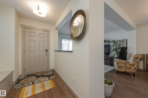 Entryway with dark wood finished floors and a textured ceiling - 17528 58 Street, Edmonton, AB - Indoor Photo Showing Other Room