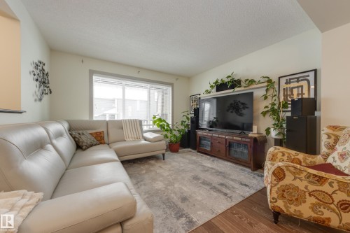 Living room with wood finished floors and a textured ceiling - 17528 58 Street, Edmonton, AB - Indoor Photo Showing Living Room