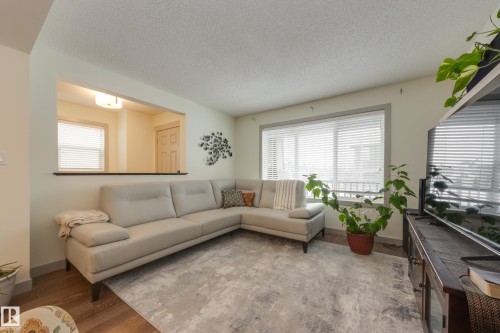Living room with a textured ceiling and wood finished floors - 17528 58 Street, Edmonton, AB - Indoor Photo Showing Living Room