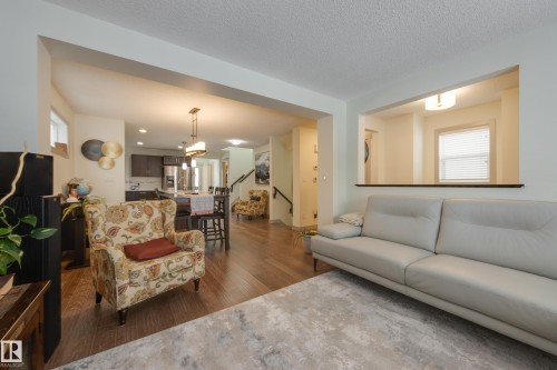 Living area featuring dark wood finished floors and a textured ceiling - 17528 58 Street, Edmonton, AB - Indoor Photo Showing Living Room