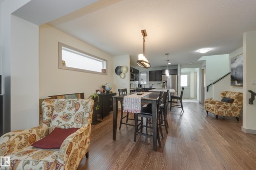 Dining area featuring plenty of natural light and dark wood-style floors - 17528 58 Street, Edmonton, AB - Indoor Photo Showing Dining Room