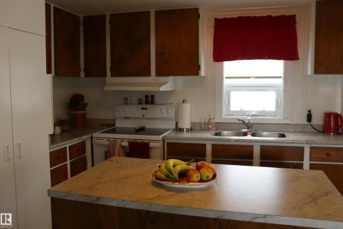 Island - 56 4204 47St., Wetaskiwin, AB - Indoor Photo Showing Kitchen With Double Sink