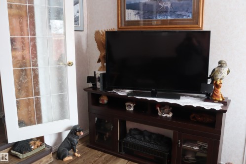 Electric Fireplace and cabinet - 56 4204 47St., Wetaskiwin, AB - Indoor With Fireplace