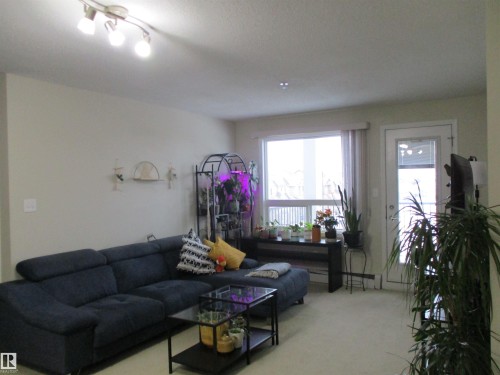 Living area with light carpet - 3309 9351 Simpson Drive, Edmonton, AB - Indoor Photo Showing Living Room