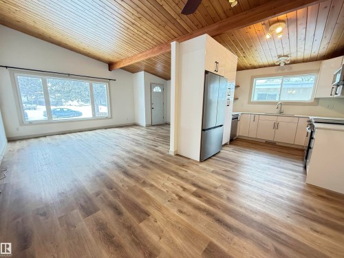 Kitchen with ceiling fan, light countertops, wooden ceiling, stainless steel appliances, and open shelves - 9034 60 Street, Edmonton, AB - Indoor